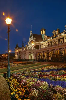 Flower garden and historic Railway Station at night, Dunedin, South Island, New Zealand Flower garden and historic Railway Station at night, Dunedin, South Island, New Zealand