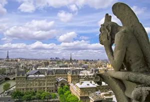 Gargoyle on the roof of Notre Dame cathedral looks out over Paris, France Gargoyle on the roof of Notre Dame cathedral looks out over Paris, France