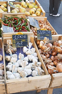 Garlic, onions and pimiento peppers for sale at a market stall at the street market in Garlic, onions and pimiento peppers for sale at a market stall at the street market in
