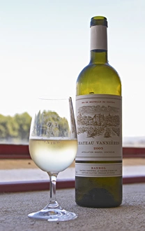 Glass of white wine with the text Chateau Vannieres and a bottle of white wine Chateau Glass of white wine with the text Chateau Vannieres and a bottle of white wine Chateau