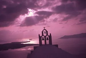 Greece, Aegean Sea, Santorini Island (Thera), Church steeple with evening light rays Greece, Aegean Sea, Santorini Island (Thera), Church steeple with evening light rays