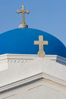 Greece, Mykonos. Blue Greek Orthodox church dome and crosses against blue sky Greece, Mykonos. Blue Greek Orthodox church dome and crosses against blue sky