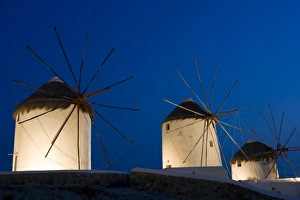 Greece, Mykonos, Hora. Three windmills lit at sunset Greece, Mykonos, Hora. Three windmills lit at sunset