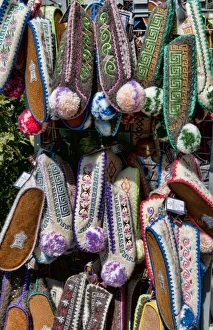 Greek souvenir shoes on rack in downtown shopping area of Plaka, Athens, Greece Greek souvenir shoes on rack in downtown shopping area of Plaka, Athens, Greece