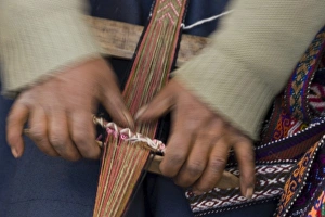 Hands weaving on traditional foot loom, Cuzco, Peru Hands weaving on traditional foot loom, Cuzco, Peru