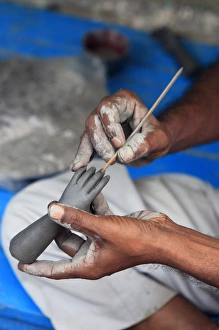 Hands working on a hand in the potters village of Kumartuli in Calcutta Hands working on a hand in the potters village of Kumartuli in Calcutta
