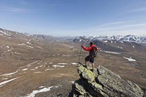 A hiker looks across the upper Nigu River Valley in Gates of the Arctic National Park A hiker looks across the upper Nigu River Valley in Gates of the Arctic National Park