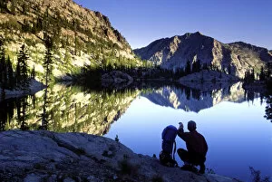 Images Dated 3rd November 2004: Hiker at sunset overlooking Looking Glass Lake in the Eagle Cap Wilderness, Oregon
