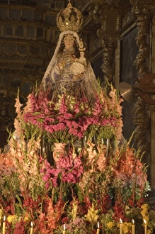 Huge display of flowers and candles under statue of Virgin Purificada Huge display of flowers and candles under statue of Virgin Purificada