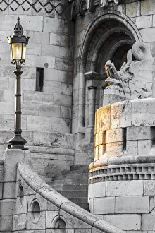 Hungary, Budapest. Light hitting lamppost, staircase, and dragon statue on Fisherman' Hungary, Budapest. Light hitting lamppost, staircase, and dragon statue on Fisherman'