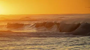 Incoming surf waves at sunrise near Poipu in Kauai, Hawaii, USA Incoming surf waves at sunrise near Poipu in Kauai, Hawaii, USA