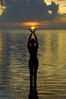 Indonesia, Bali. Woman silhouetted at sunrise on Sanur Beach. Credit as: Jones-Shimlock Indonesia, Bali. Woman silhouetted at sunrise on Sanur Beach. Credit as: Jones-Shimlock
