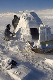 inupiat guides Bruce Inglangasak and Jack Kayotuk finish building an igloo snow blind inupiat guides Bruce Inglangasak and Jack Kayotuk finish building an igloo snow blind
