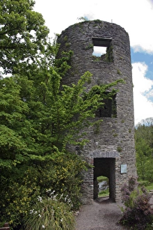 In Ireland, at the Blarney Castlea stone tower ruin in the castle garden among trees In Ireland, at the Blarney Castlea stone tower ruin in the castle garden among trees