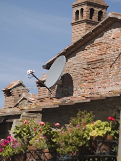 Italy, Cortona, Satelite TV dishes contrast with older houses Italy, Cortona, Satelite TV dishes contrast with older houses