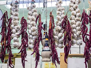 Italy, Florence. Garlic and peppers for sale hanging in a shop in the Central Market Italy, Florence. Garlic and peppers for sale hanging in a shop in the Central Market