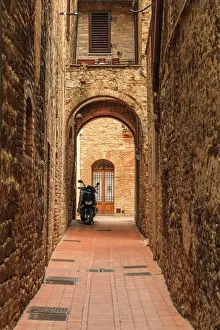 Italy, San Gimignano. Alleyway with motorbike Italy, San Gimignano. Alleyway with motorbike