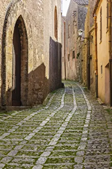 Italy, Sicily, Trapani Province, Erice. A narrow cobblestone street in the ancient hill Italy, Sicily, Trapani Province, Erice. A narrow cobblestone street in the ancient hill