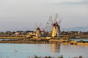 Italy, Sicily, Trapani Province, Marsala. Wind mills at the salt evaporation ponds in the Italy, Sicily, Trapani Province, Marsala. Wind mills at the salt evaporation ponds in the