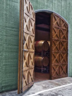 Italy, Tuscany. Beautiful wooden doors leading to a barrel room at a winery Italy, Tuscany. Beautiful wooden doors leading to a barrel room at a winery