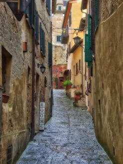 Italy, Tuscany. A narrow street scene in a village in Tuscany Italy, Tuscany. A narrow street scene in a village in Tuscany