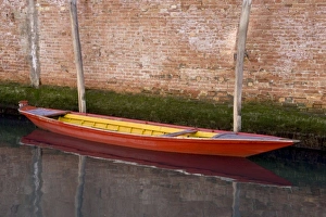 Italy, Venice. Red boat reflecting in canals still water Italy, Venice. Red boat reflecting in canals still water