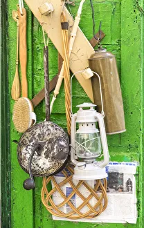 Items for sale hanging on the door of a small storefront in old town Ostuni Items for sale hanging on the door of a small storefront in old town Ostuni