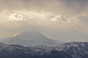 Japan, Hokkaido, Tsurui. God rays shine over mountain Japan, Hokkaido, Tsurui. God rays shine over mountain