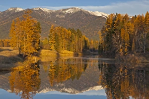Jessup Mill Pond in autumn with snow capped Swan Mountains near Creston, Montana, USA Jessup Mill Pond in autumn with snow capped Swan Mountains near Creston, Montana, USA