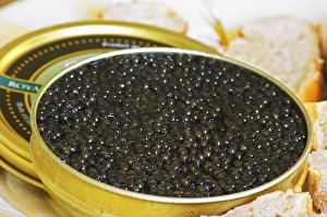 A just open tin of black caviar with slices of bread Caviar et Prestige" A just open tin of black caviar with slices of bread Caviar et Prestige"