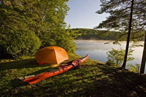 A kayak and a tent next to the Androscoggin River at a remote campsite at Mollidgewock A kayak and a tent next to the Androscoggin River at a remote campsite at Mollidgewock