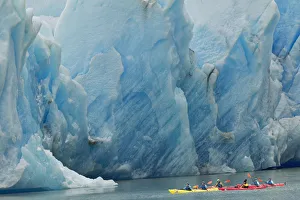 Kayakers exploring Grey Lake in front of massive Grey Glacier, Torres del Paine National Park Kayakers exploring Grey Lake in front of massive Grey Glacier, Torres del Paine National Park