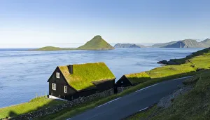Koltur island at sunrise, the island Vagar in the background, village Velbastadur in the foreground Koltur island at sunrise, the island Vagar in the background, village Velbastadur in the foreground