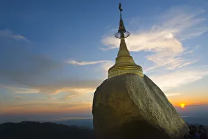 Kyaiktiyo Pagoda (Gold Rock) at sunset, a small pagoda built on the top of a granite Kyaiktiyo Pagoda (Gold Rock) at sunset, a small pagoda built on the top of a granite