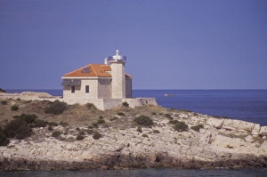 A lighthouse anchors the south east tip of the island of Solta. Adriatic Sea. Croatia A lighthouse anchors the south east tip of the island of Solta. Adriatic Sea. Croatia