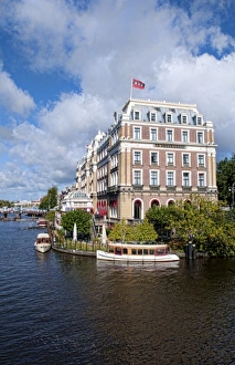 Local working boats on the canals in Amsterdam, the Netherlands Local working boats on the canals in Amsterdam, the Netherlands
