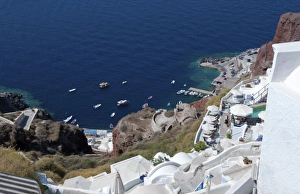 Looking down at fishing village in Oia in Santorini Greece in the Greek Islands Looking down at fishing village in Oia in Santorini Greece in the Greek Islands