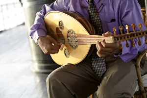Man playing traditional Egyptian instrument. En Route to Luxor on the SS Sudan, Egypt Man playing traditional Egyptian instrument. En Route to Luxor on the SS Sudan, Egypt
