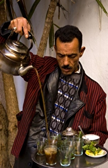 Man pouring tea for sale in Medina area of Tunis Tunisia of Northern Africa Man pouring tea for sale in Medina area of Tunis Tunisia of Northern Africa