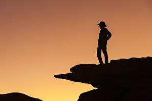 Man standing on rock surveying the view. (MR) Man standing on rock surveying the view. (MR)