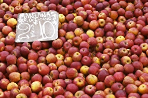 A market stall street market merchant selling apples in a big pile, Manzana Red Delicious A market stall street market merchant selling apples in a big pile, Manzana Red Delicious
