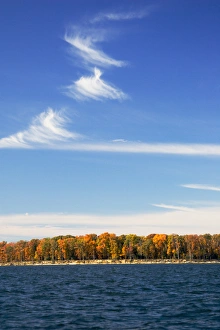 MARYLAND. USA. Cirrus fibratus clouds above colorful foliage & Chesapeake Bay in autumn MARYLAND. USA. Cirrus fibratus clouds above colorful foliage & Chesapeake Bay in autumn