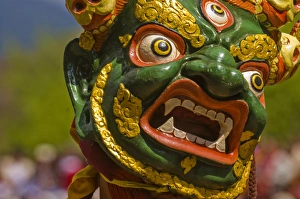 Mask of dancer at religious festivity with many visitors, Paro Tsechu, Bhutan, Asia Mask of dancer at religious festivity with many visitors, Paro Tsechu, Bhutan, Asia