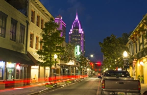 Mobile Alabama downtown traffic on Dauphin Street at twilight with Trustmark Skyscrapper Mobile Alabama downtown traffic on Dauphin Street at twilight with Trustmark Skyscrapper