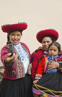 Modern life in Peru family in traditional dress and hat taking photo with cell phone communicating Modern life in Peru family in traditional dress and hat taking photo with cell phone communicating