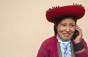 Modern life in Peru woman in traditional dress and hat with cell phone communicating via Modern life in Peru woman in traditional dress and hat with cell phone communicating via