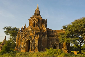 Myanmar. Bagan. Red brick temple glows in the late afternoon light Myanmar. Bagan. Red brick temple glows in the late afternoon light