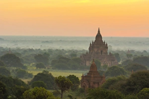 Myanmar. Bagan. Smoke from cooking fires shrouds the temples of Bagan at sunrise Myanmar. Bagan. Smoke from cooking fires shrouds the temples of Bagan at sunrise