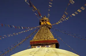Kathmandu City Landmarks Prints: Nepal, Kathmandu. Under prayer flags, watchful eyes of Buddha gaze from Bodhnath Stupa, c