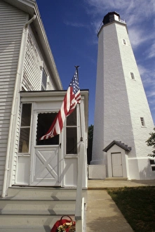 New Jersey: Gateway National Recreation Area, Sandy Hook LIghthouse (built 1764) with American flag New Jersey: Gateway National Recreation Area, Sandy Hook LIghthouse (built 1764) with American flag